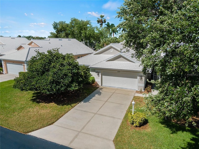 view of front of house with a front yard and a garage