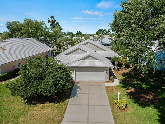 view of front of house with a front yard and a garage