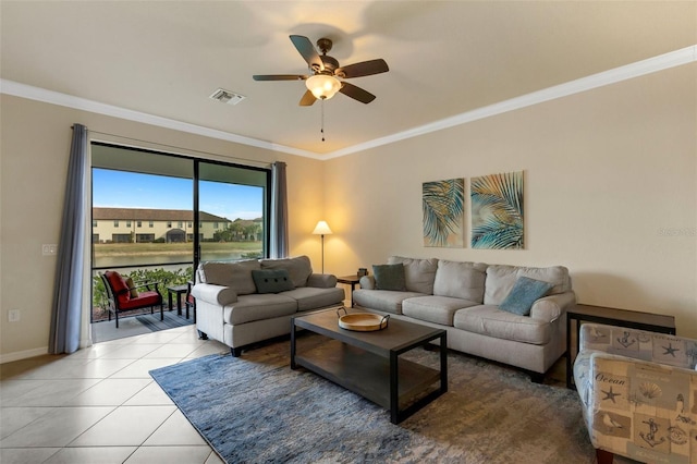 tiled living room with ceiling fan and ornamental molding