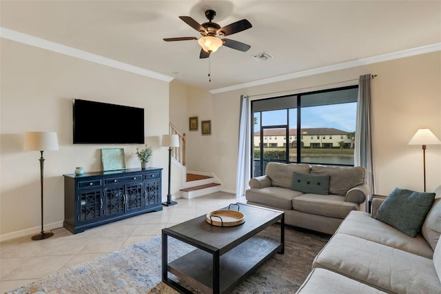 tiled living room with ceiling fan and ornamental molding