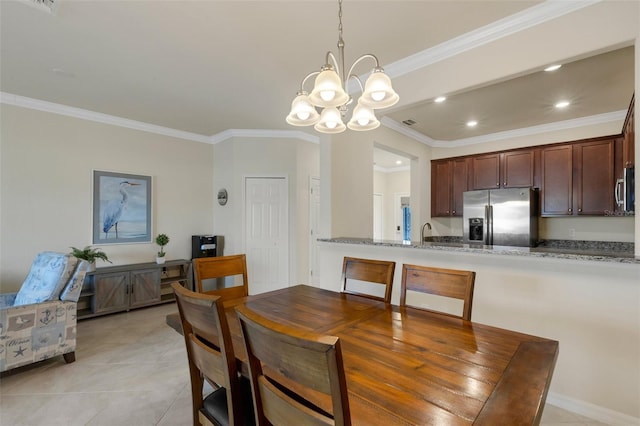 dining room with sink, light tile patterned floors, crown molding, and a chandelier