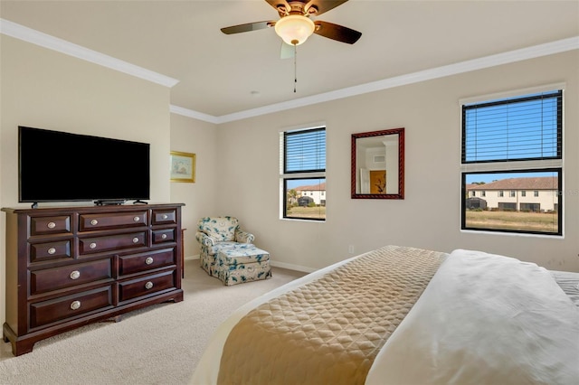 carpeted bedroom with ceiling fan and ornamental molding