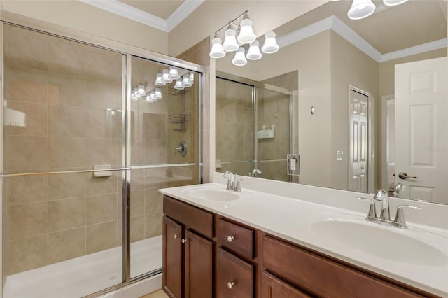 bathroom with vanity, ornamental molding, and an enclosed shower