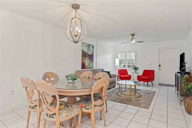 tiled dining area featuring ceiling fan with notable chandelier