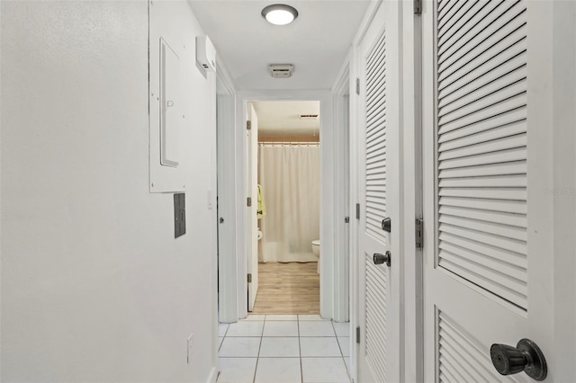 hall with light tile patterned floors