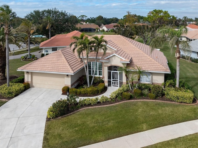 view of front of home featuring a garage and a front lawn