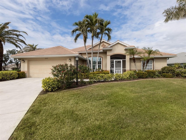 ranch-style home with a garage and a front lawn