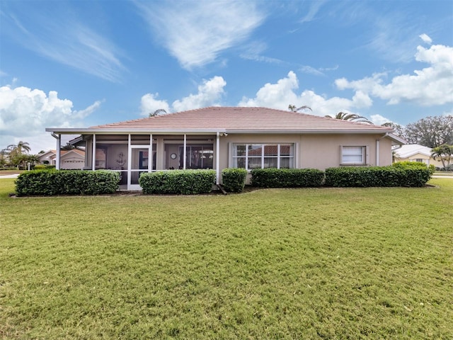 back of house with a sunroom and a yard