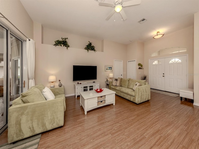 living room with ceiling fan and light hardwood / wood-style flooring