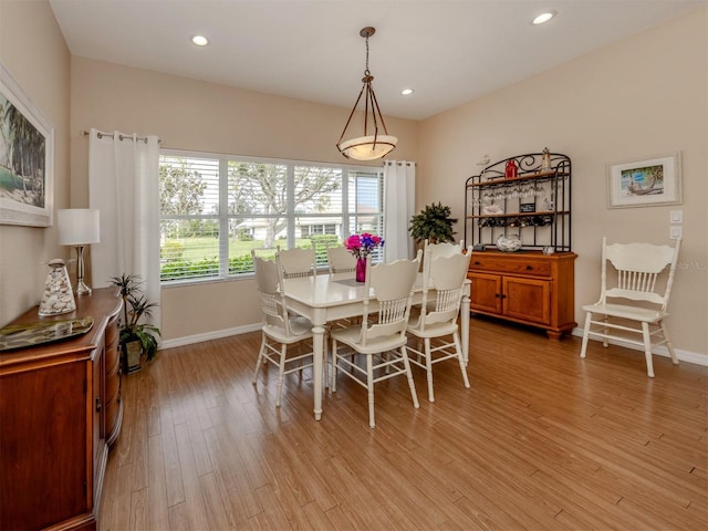 dining space with light hardwood / wood-style flooring