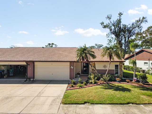 single story home with a garage and a front lawn