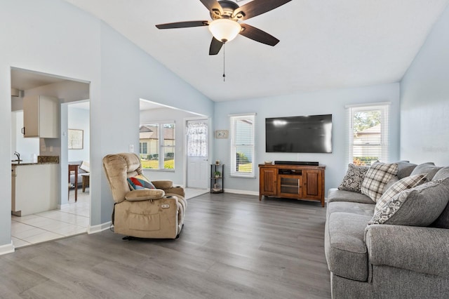 living room with hardwood / wood-style flooring, ceiling fan, and lofted ceiling