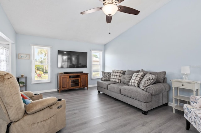 living room with ceiling fan, lofted ceiling, plenty of natural light, and wood-type flooring