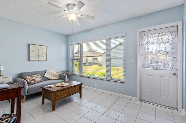 tiled living room with a textured ceiling and ceiling fan