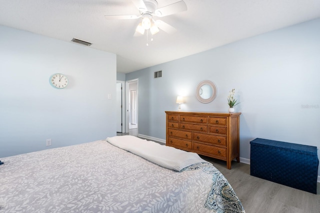 bedroom with ceiling fan and light wood-type flooring