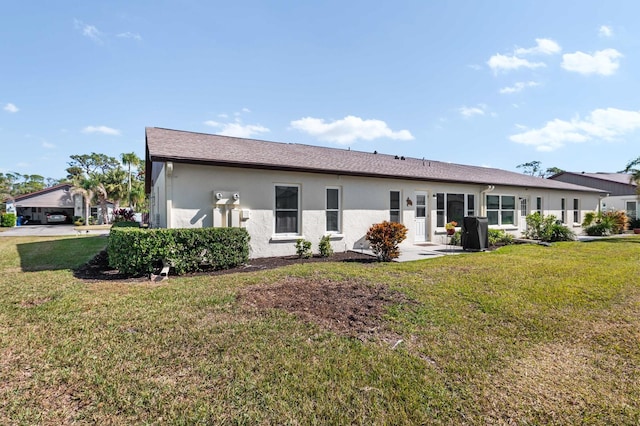 rear view of property featuring a yard