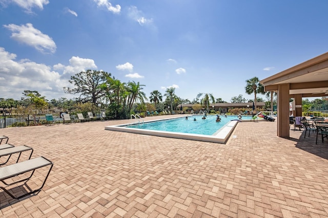 view of swimming pool with a patio area