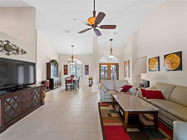 living room featuring light tile patterned floors, ceiling fan with notable chandelier, french doors, and high vaulted ceiling