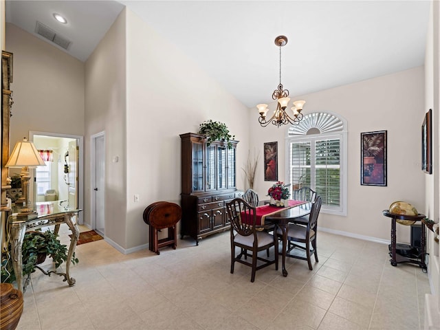 tiled dining room with a chandelier