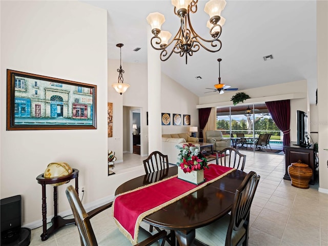 dining area featuring ceiling fan with notable chandelier, light tile patterned floors, and high vaulted ceiling