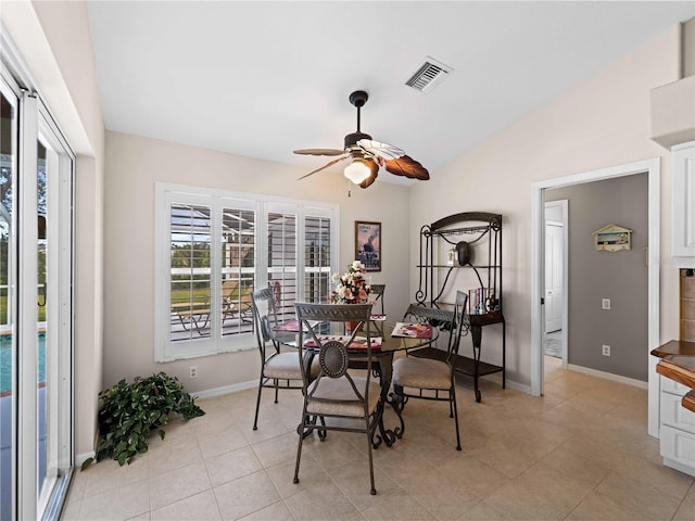 dining area with lofted ceiling, light tile patterned floors, and ceiling fan