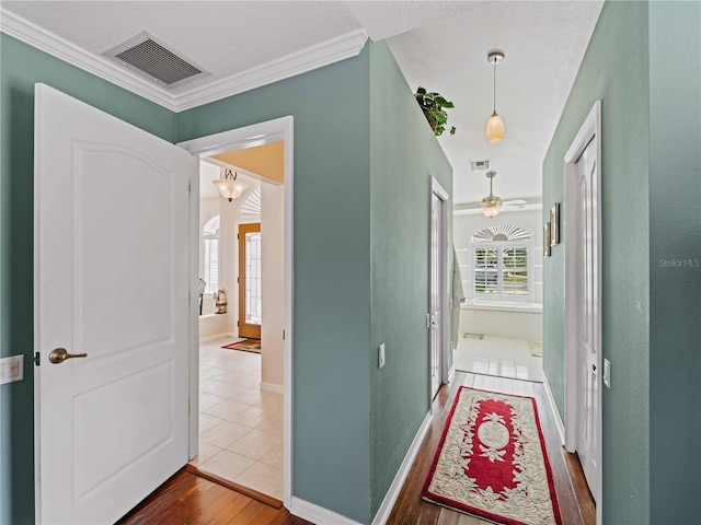 hallway featuring crown molding and wood-type flooring