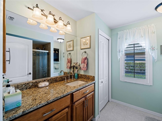 bathroom with walk in shower and vanity