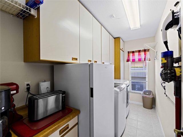 laundry room featuring cabinets and washing machine and clothes dryer