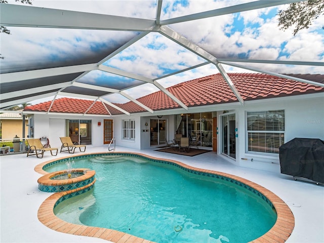 view of swimming pool with a lanai, a grill, and a patio