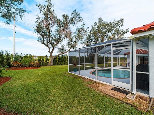 view of swimming pool with a lanai and a yard