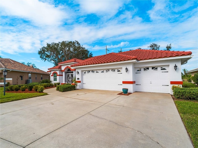 mediterranean / spanish house with a garage