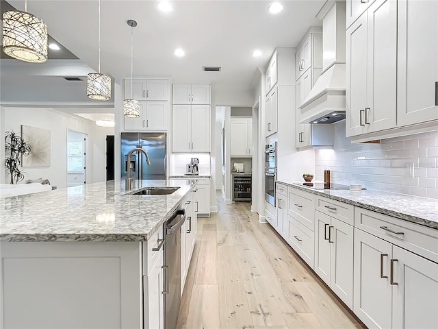 kitchen featuring hanging light fixtures, white cabinets, and a spacious island