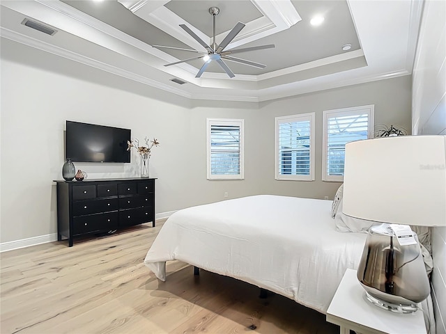 bedroom with a tray ceiling, crown molding, light hardwood / wood-style floors, and ceiling fan