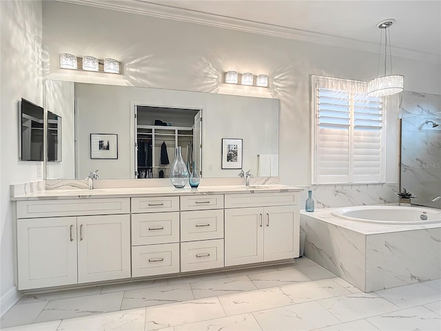 bathroom with ornamental molding, a relaxing tiled tub, and vanity