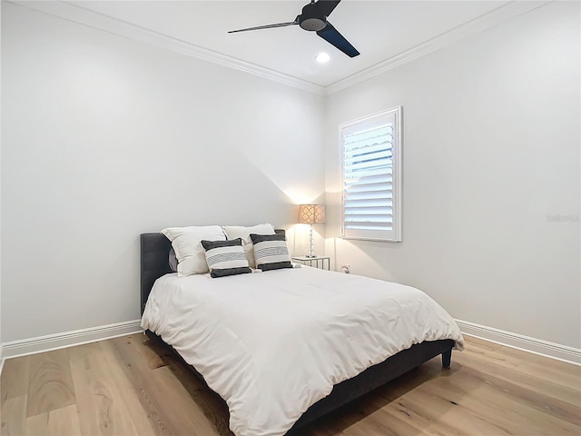 bedroom with ceiling fan, ornamental molding, and hardwood / wood-style floors