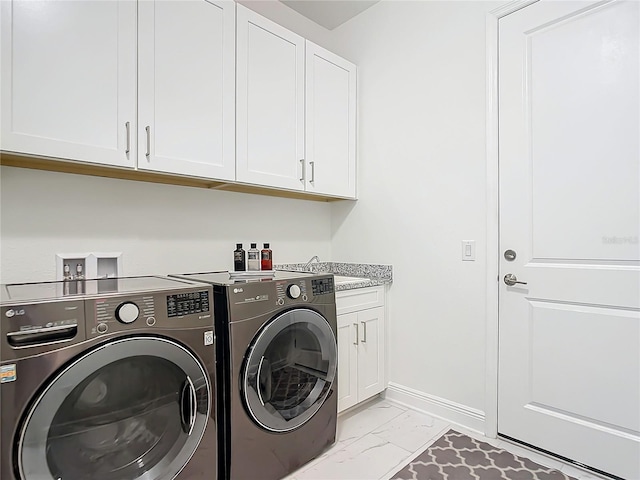 laundry area with sink, washer and clothes dryer, and cabinets