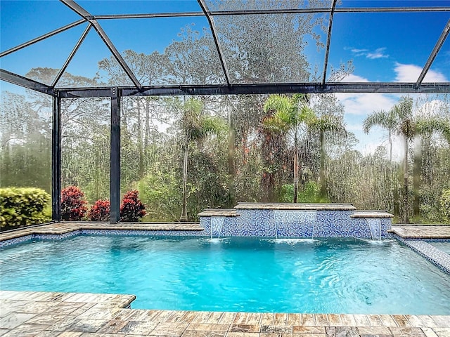 view of swimming pool featuring pool water feature and glass enclosure