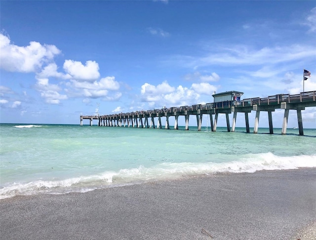 dock area featuring a water view and a view of the beach