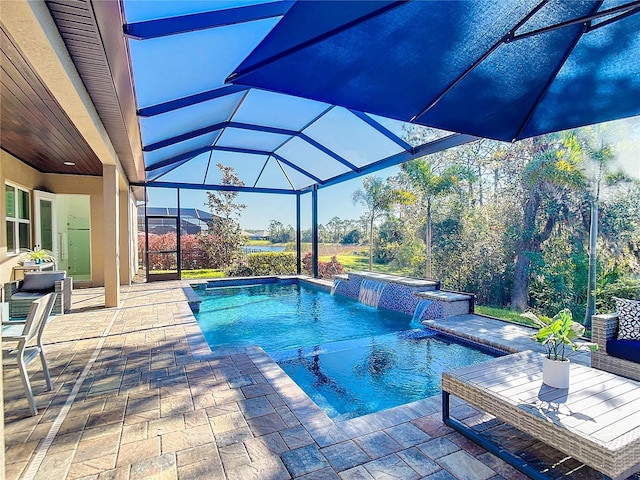 view of swimming pool with a patio, a jacuzzi, pool water feature, and a lanai