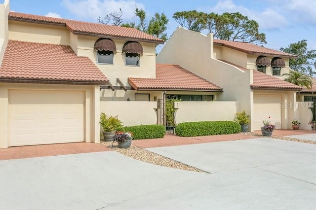 mediterranean / spanish-style house with a garage