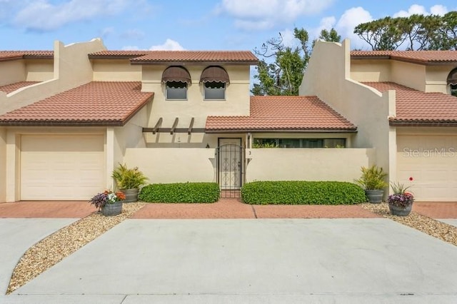 mediterranean / spanish home with a garage