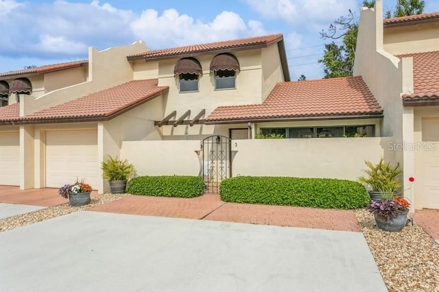 mediterranean / spanish house featuring a garage