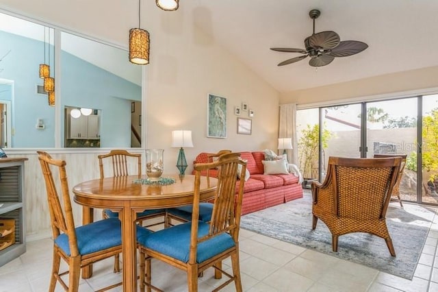 tiled dining space with vaulted ceiling and ceiling fan