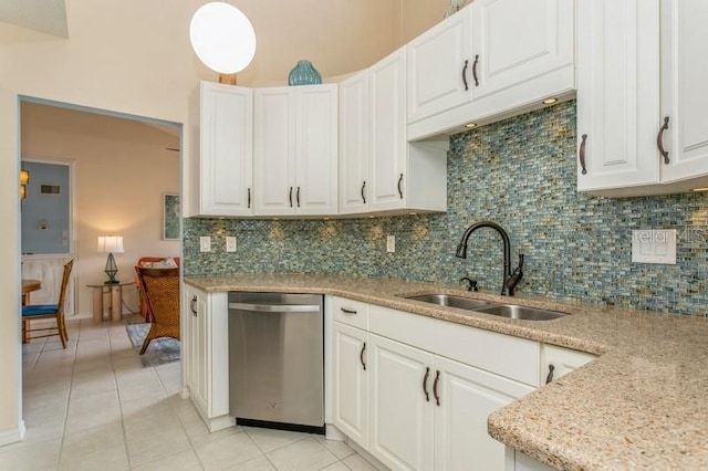 kitchen featuring dishwasher, sink, backsplash, white cabinetry, and light tile patterned floors