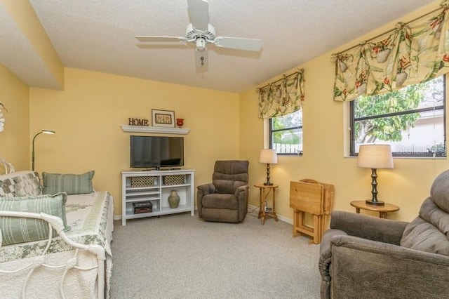 living room featuring carpet floors, a textured ceiling, and ceiling fan