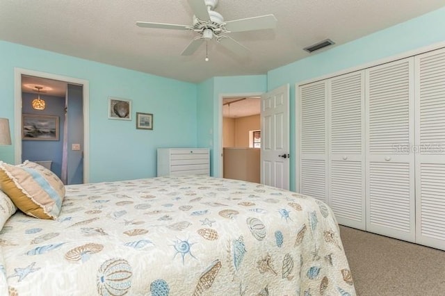 bedroom with a closet, ceiling fan, and carpet flooring