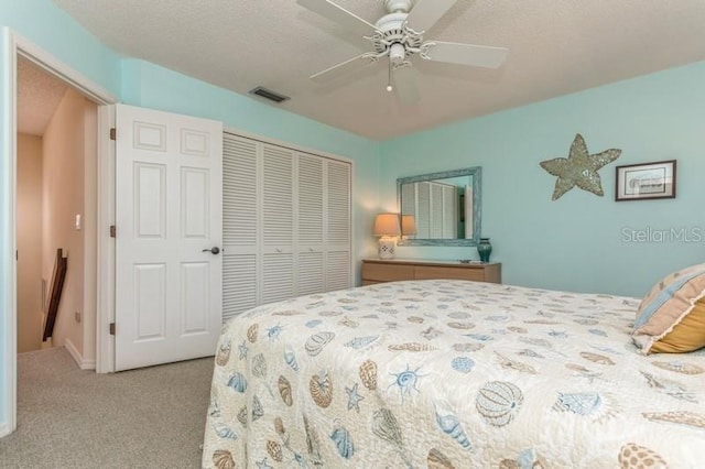 carpeted bedroom featuring a closet and ceiling fan