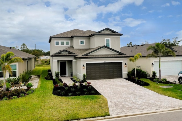 view of front of home featuring a garage and a front lawn