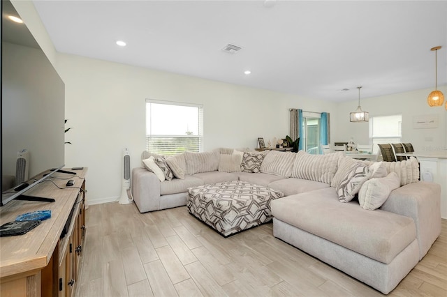 living room featuring a healthy amount of sunlight and light wood-type flooring