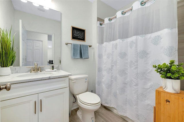 bathroom featuring hardwood / wood-style flooring, vanity, and toilet